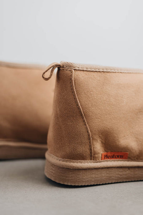 Close up view of Noah Tabac Sheepskin Slippers with Heatons label detail on Concrete Surface