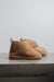 Side view of Noah Tabac Sheepskin Slippers on Concrete Surface