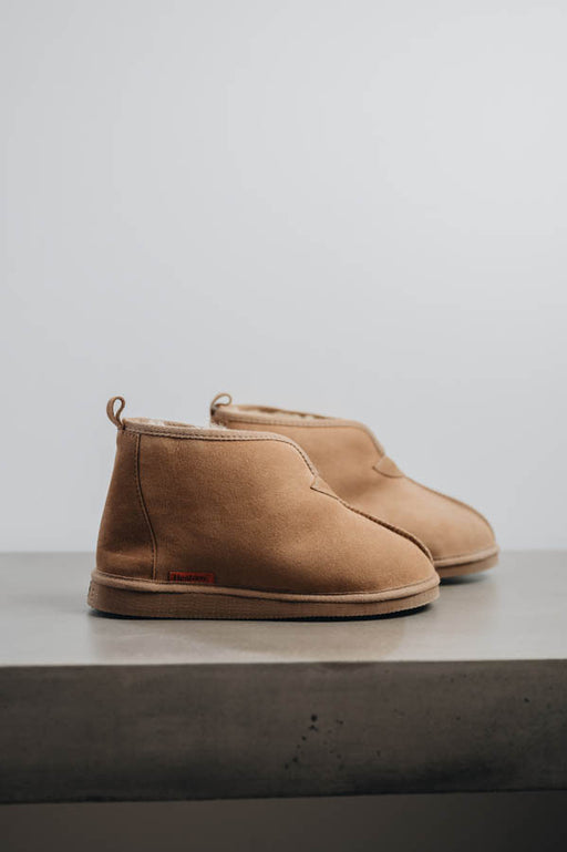 Side view of Noah Tabac Sheepskin Slippers on Concrete Surface