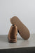 Noah Tabac Sheepskin Slippers showing the bottom of the EVA sole on a Concrete Surface