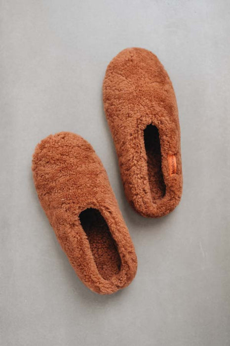Pair of rust coloured curly sheepskin slippers - birds eye view