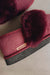 Close-up of a pair of Heatons slippers featuring deep burgundy full sheepskin cuff, suede outer and a dark grey textured sole