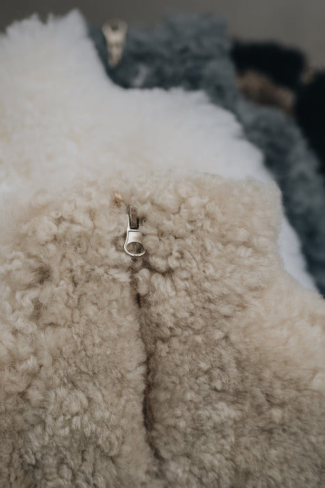 Close up of a sheepskin hot water bottle cover, to show its zipped opening