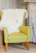 Fireside  appeal - All Natural British Sheepskin Rugs - Natural white nestled in the back of a high backed  chair by the fire