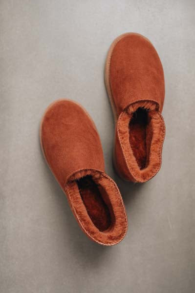Birds eye view of Tilly rust coloured sheepskin slipper showing plush natural sheepskin wool inside