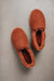 Birds eye view of Tilly rust coloured sheepskin slipper showing plush natural sheepskin wool inside
