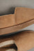 Close up of a clean loafer style tan sheepskin slipper, hand crafted from Spanish merino sheepskin.