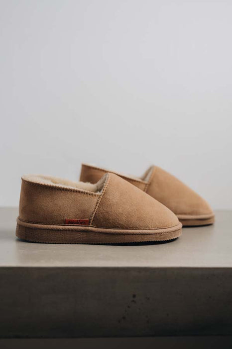 Side view of clean loafer style sheepskin slipper, hand crafted from Spanish merino sheepskin.