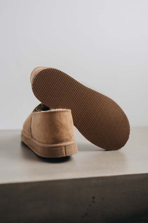 Bottom view of clean loafer style sheepskin slipper showing the sole, hand crafted from Spanish merino sheepskin.