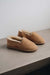 Side view of clean loafer style sheepskin slipper, hand crafted from Spanish merino sheepskin.