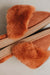 Close up view of Veronica Rust Sheepskin Slippers Sole to Sole on a Concrete Surface