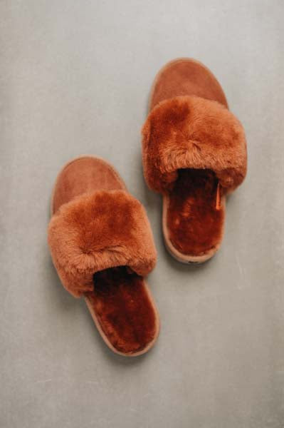 Birds eye view of Veronica Rust Sheepskin Slippers on Concrete Surface