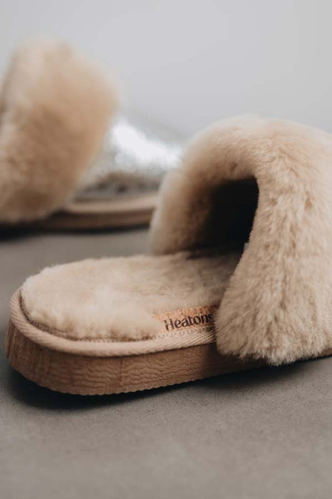 Close up view of Veronica Titanium Sheepskin Slippers with Heatons label detail on Concrete Surface