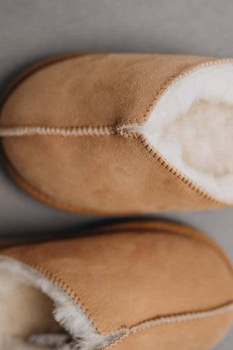 Close up of tan coloured slip on style sheepskin slipper 